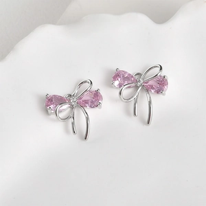 Detail of pink pear-cut zircon butterfly bow earrings in polished silver finish