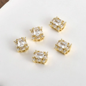 Close-up of 14K gold plated rectangular zircon beads with hollow side patterns