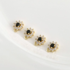 Detailed set of four 14k gold-plated flower pendants with black stones and zircon pavé