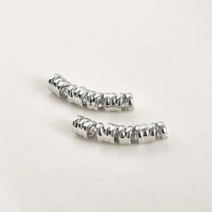 Close-up of spiral metal tube beads for DIY jewelry and hair braid accessories