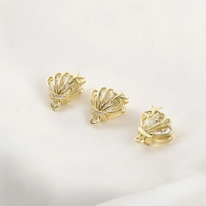 Detail of 14k gold plated starfish shell pendants with cubic zirconia for jewelry making