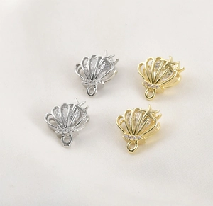 Macro detail of gold and silver starfish shell pendants with cubic zirconia for DIY jewelry