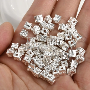 Macro shot of silver plated cube beads with hammered texture for DIY jewelry making
