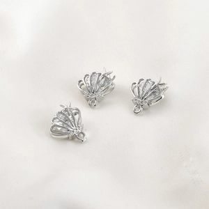 Macro shot of silver shell pendant with cubic zirconia for DIY jewelry making