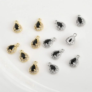 Close-up of 14k gold plated pear-shaped black zircon charms for DIY jewelry making