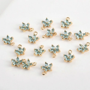 Détails de pendentifs fleur à cinq pétales dorés avec zircons bleu clair