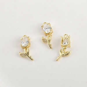 Close-up of 14k gold-plated tulip pendants with sparkling cubic zirconia for DIY jewelry