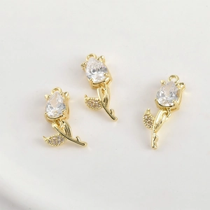 Macro shot of 14k gold tulip charms with teardrop cubic zirconia for DIY jewelry