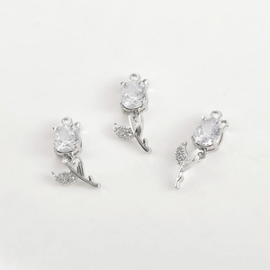 Macro view of three tulip pendants with pear-cut zircon and silver-plated finish