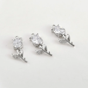 Detailed close-up of three tulip pendants with clear zircons and silver-plated finish