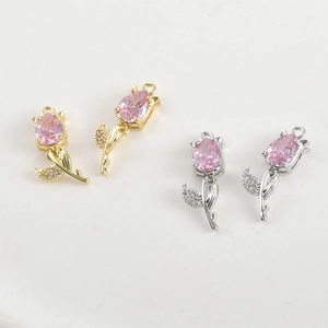 Detail of 14k gold plated tulip pendants with pink crystal drops and white zircon inlay