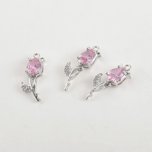 Close-up of 14k gold plated tulip pendants with pink zircon and leaf detail