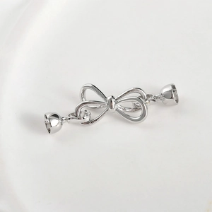 Close-up of silver bow jewelry clasp connector for DIY necklace and bracelet crafting