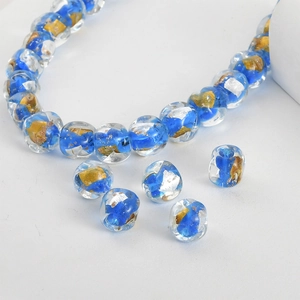 Macro detail of royal blue handmade glass beads with gold foil for jewelry making