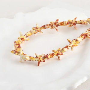 Close-up of starfish beads with vintage oil painting texture on a decorative wave plate