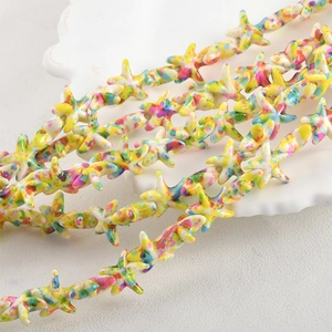 Macro shot of colorful starfish beads with marble texture for DIY jewelry making