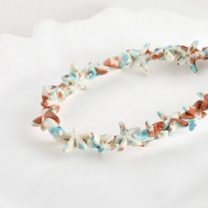Macro detail of vintage oil painting style starfish beads with mottled turquoise glaze