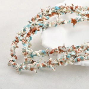Close-up of vintage starfish beads with turquoise oil painting texture for jewelry DIY