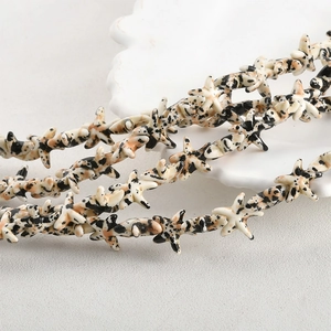 Macro shot of starfish beads with dalmatian stone patterns for DIY jewelry making