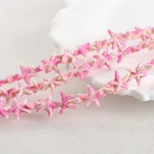Detail view of pink and white synthetic turquoise starfish beads for DIY jewelry making