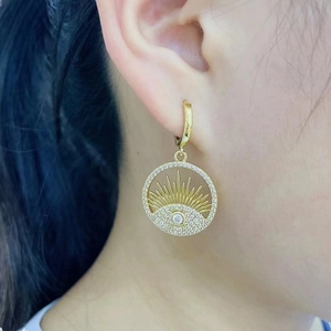 Gold evil eye hoop earrings with sparkling crystal accents and sunburst design