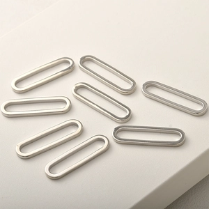 Macro detail of eight polished silver oval link connectors for DIY jewelry making
