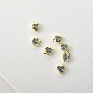 Close-up of 14k gold-plated heart charms with grey faceted crystals for jewelry making