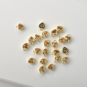 Macro shot of 14k gold plated heart pendants with champagne zircon for jewelry DIY