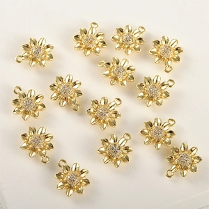 Close-up of 14 gold sunflowers with embedded zircons for DIY jewelry making