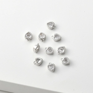 Macro shot of 14k gold-plated heart charms with clear cubic zirconia for jewelry DIY