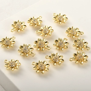 Detailed view of 14k gold-plated sunflower charms with glittering zircon centers for DIY jewelry