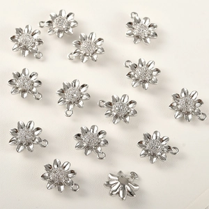 Detail of 14K gold plated sunflower pendants with cubic zirconia inlay for DIY jewelry