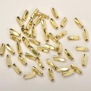 Macro shot of 14k gold-plated twisted faceted tube beads for DIY jewelry making
