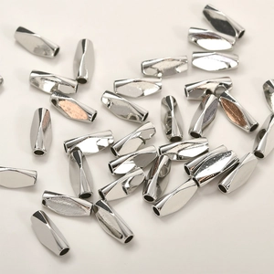 Close-up of silver-plated twisted metal tube beads for DIY jewelry making material