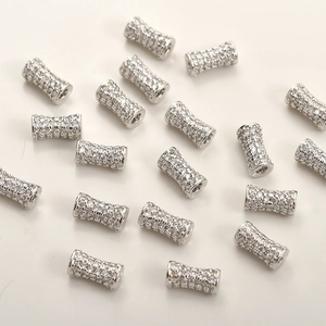 Macro shot of silver plated waist drum beads with pavé-set zircons for DIY jewelry