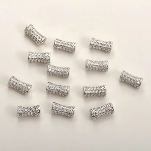Macro detail of silver cylinder beads with micro-pave cubic zirconia for DIY jewelry