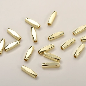 Macro view of 14k gold-plated faceted tube beads for DIY necklace and bracelet crafting