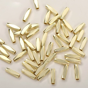 Close-up of 14k gold-plated faceted tube beads for DIY jewelry making material