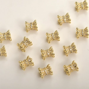 Close-up of 14k gold-plated brass bow charms with micro-pave cubic zirconia crystals
