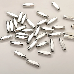 Macro view of silver faceted hollow tube metal beads for DIY jewelry making material