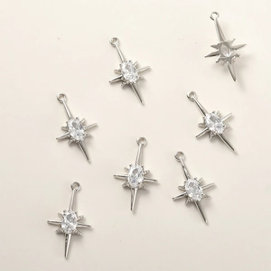 Detailed view of seven silver star charms with oval zircon for DIY jewelry making
