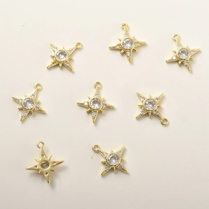 Detailed close-up of 14k gold plated star pendants with micro-paved cubic zirconia stones