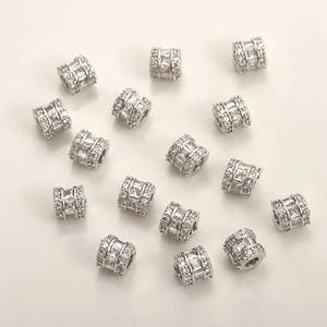 Macro view of silver cylinder spacer beads with inlaid clear cubic zirconia for DIY jewelry