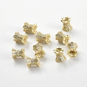 Detailed macro view of 14k gold plated waist tube beads set with sparkling zircons for DIY