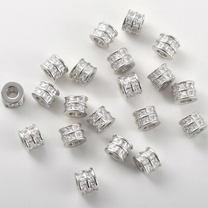 Macro shot of silver plated barrel beads with pavé set cubic zirconia for DIY jewelry