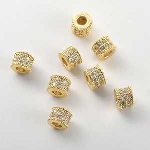 Macro shot of 14k gold plated barrel beads with pavé set cubic zirconia for DIY jewelry