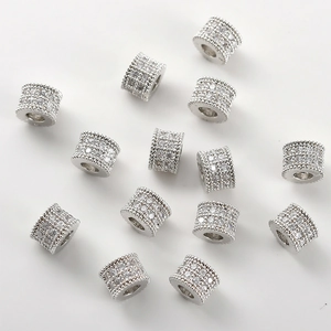 Macro detail of cylinder spacers with pavé-set zircons for DIY jewelry making