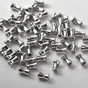 Gros plan de perles en forme de bambou argenté pour la fabrication de bijoux et loisirs