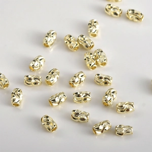 Detailed macro shot of 14k gold plated textured cylinder beads for DIY jewelry making