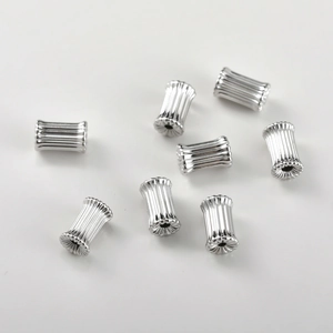 Macro detail of vertical striped silver plating cylinder beads for DIY jewelry making
